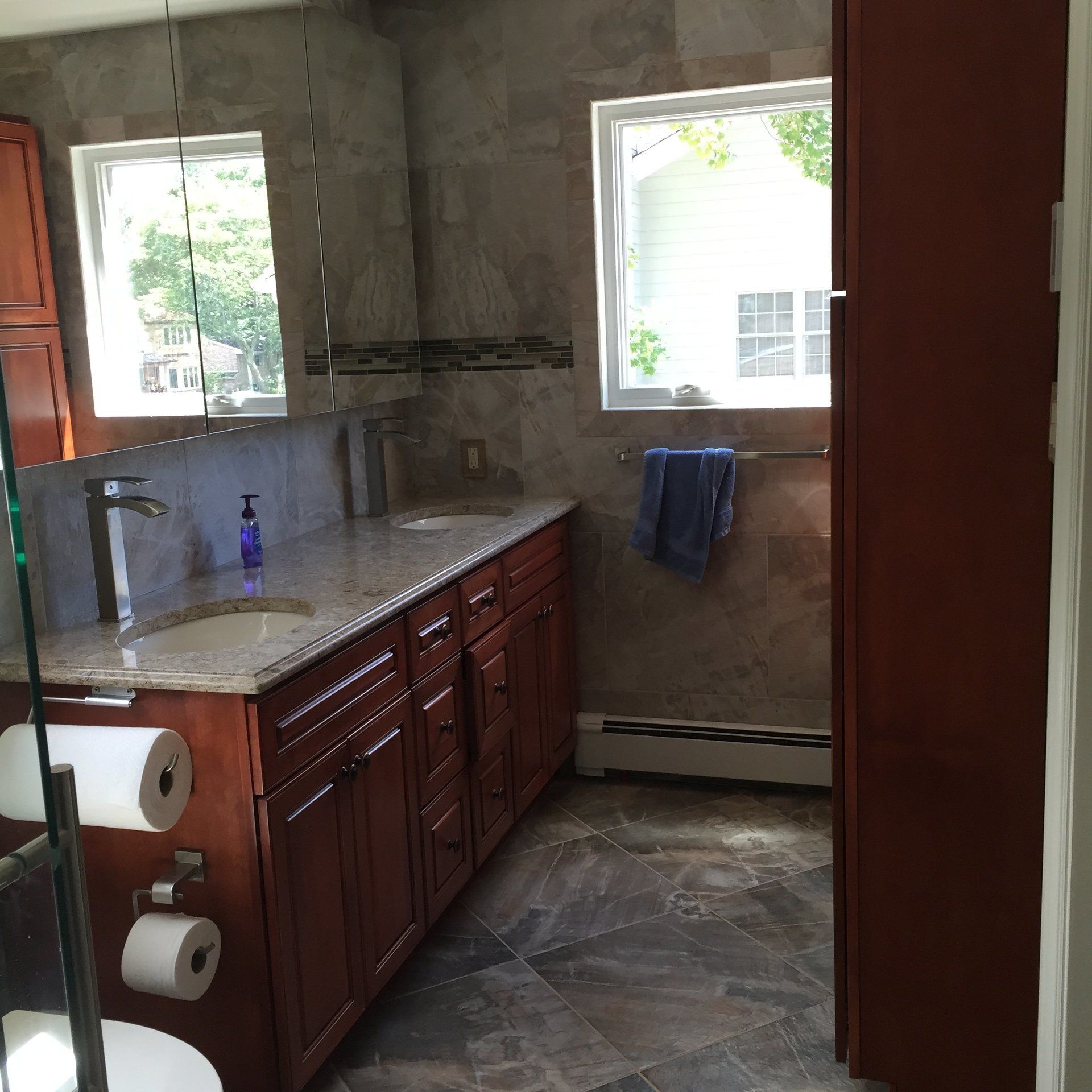remodeled bathroom with new cabinetry, flooring, and countertops