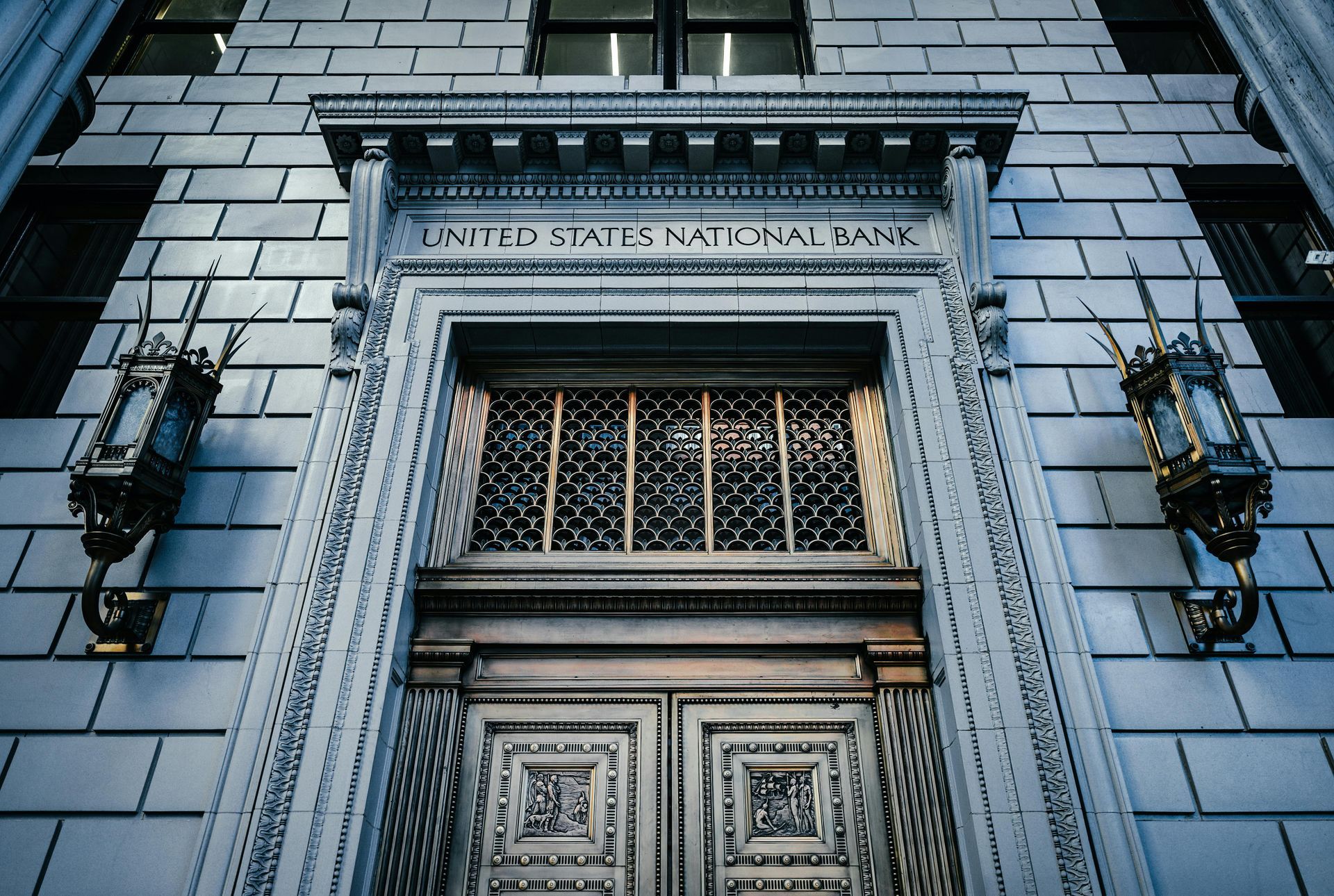 A low-angle view of an ornate stone doorway labeled 