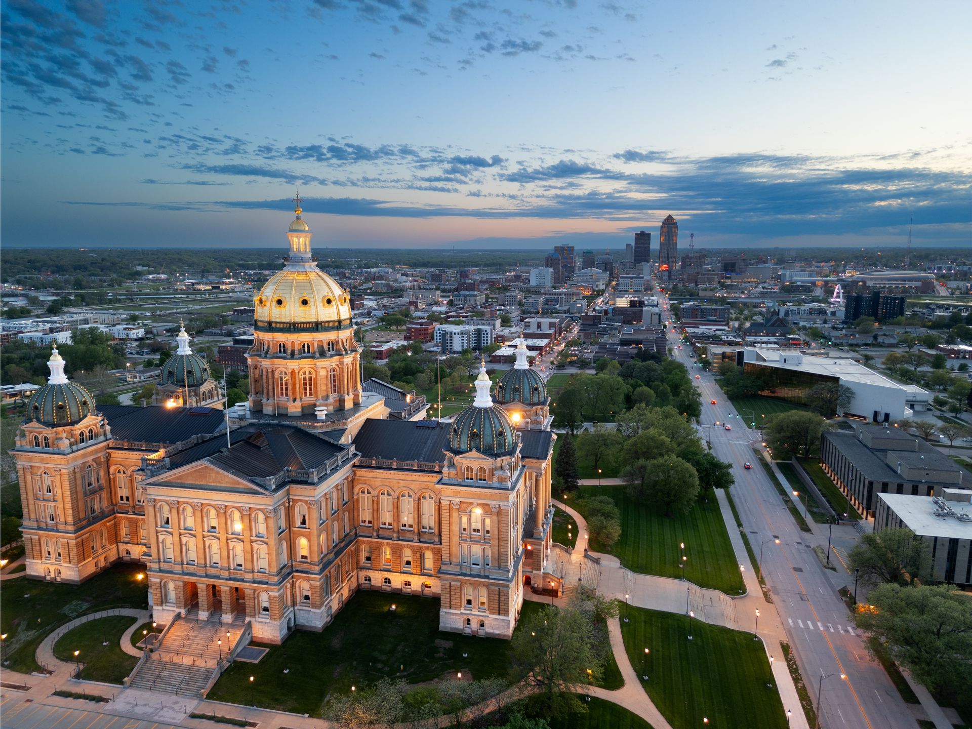 An aerial view of a large building with a dome in the middle of a city.