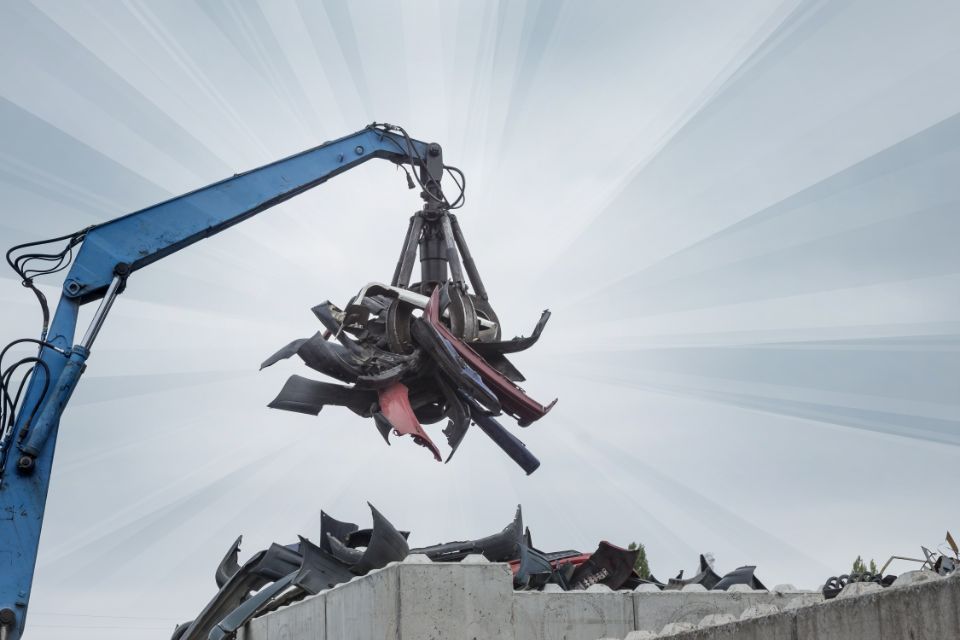 scrap  metal parts being lifted