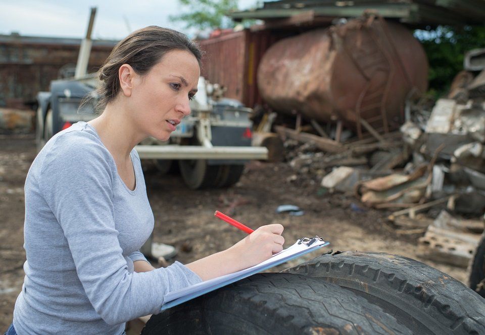 woman noting down the list of car parts