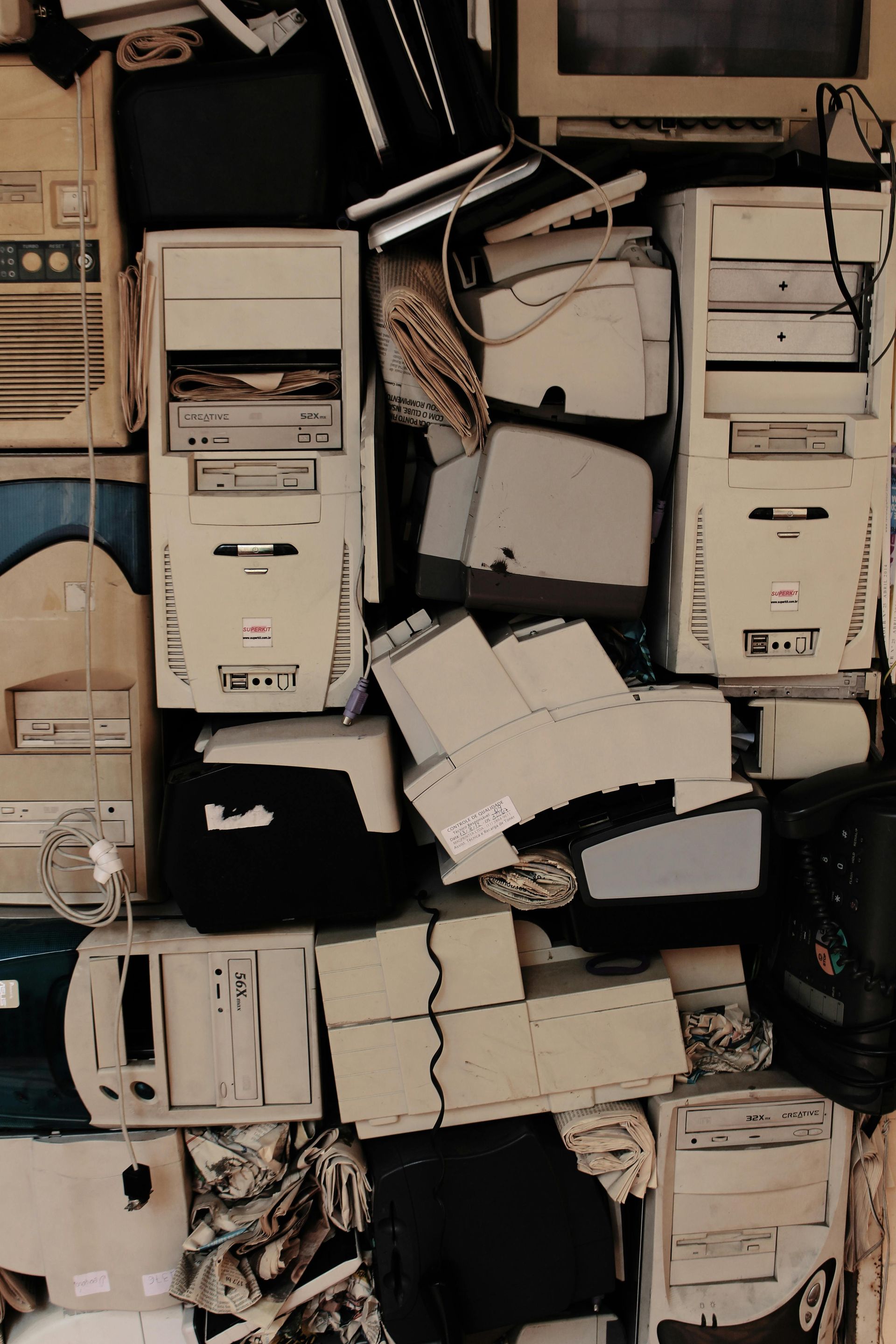 A bunch of old computers are stacked on top of each other