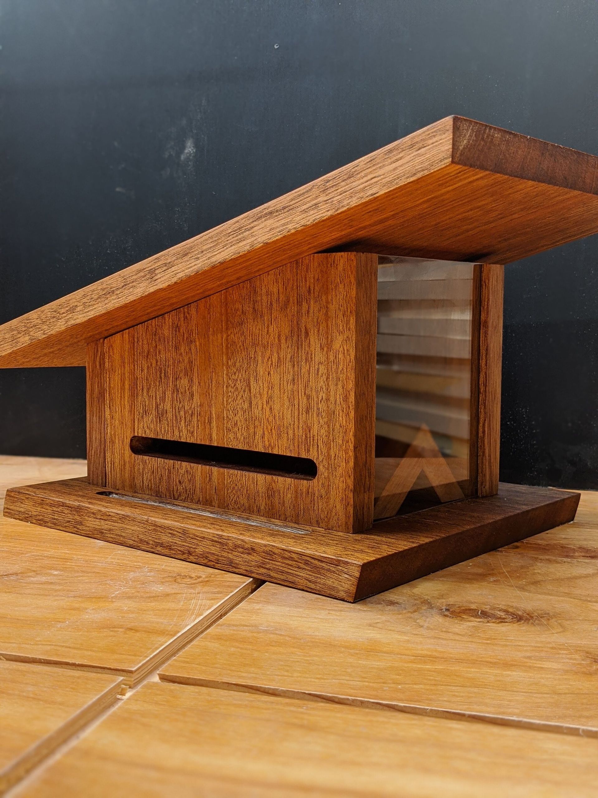 A small wooden house is sitting on a wooden floor.