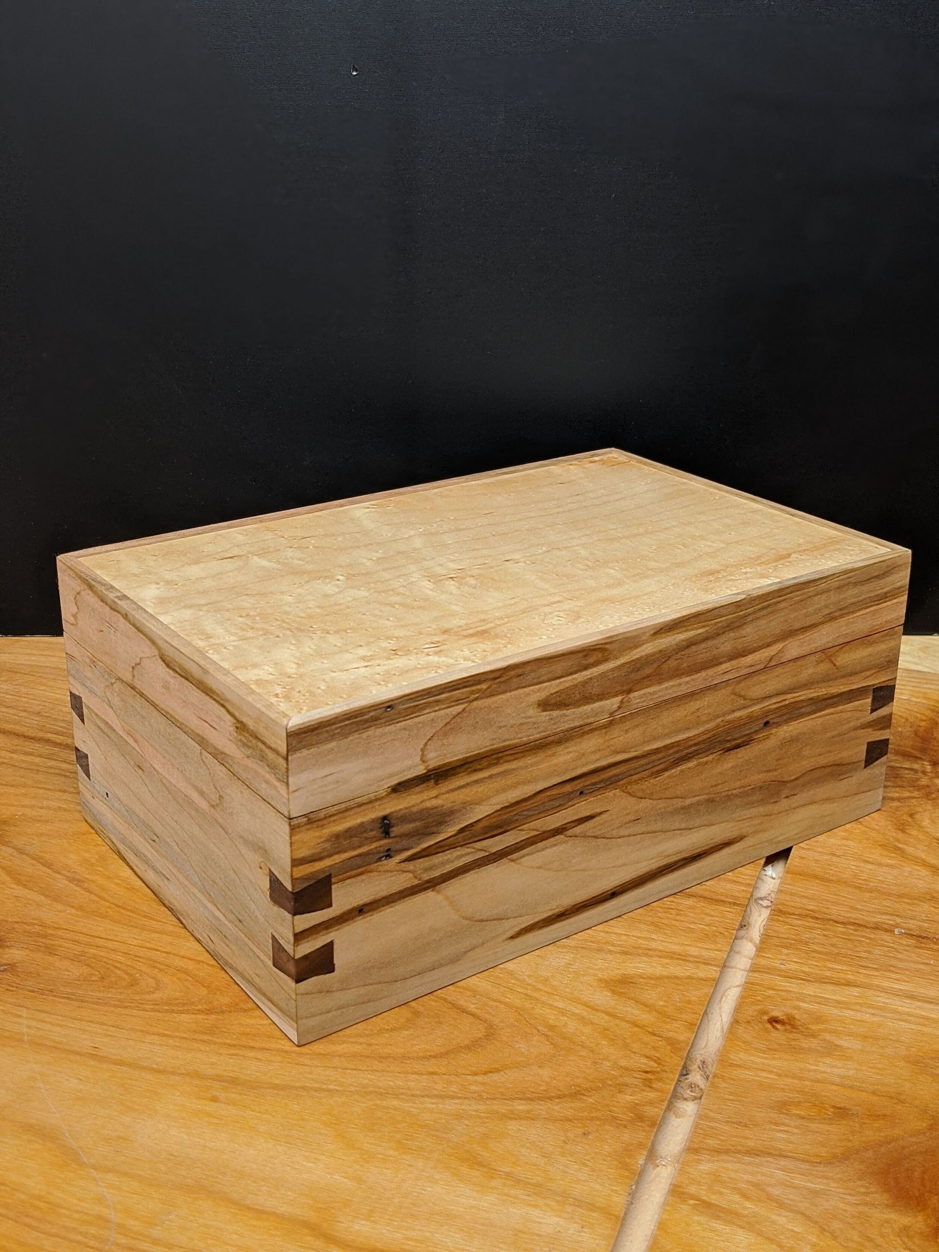 A wooden box is sitting on top of a wooden table.
