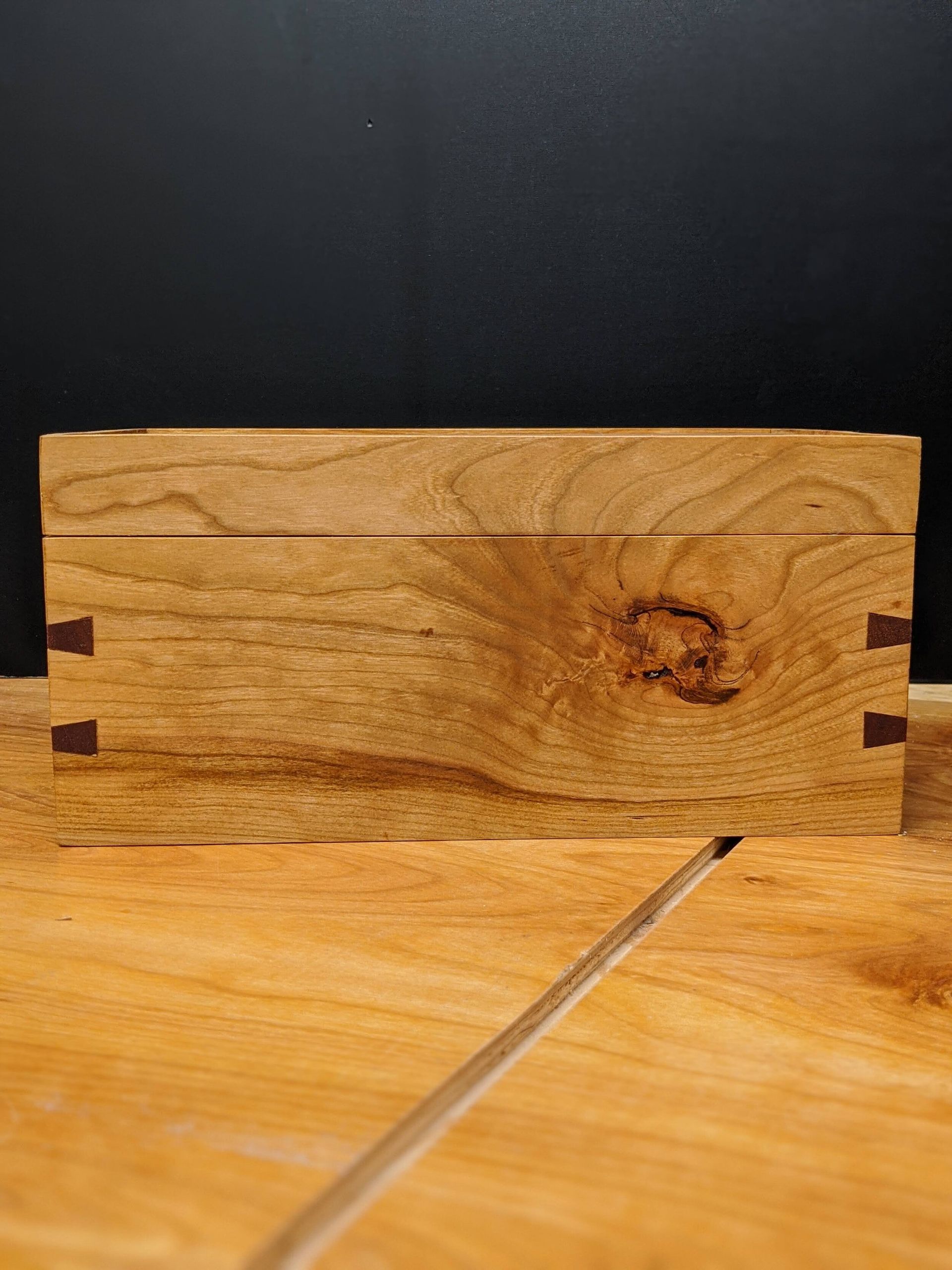 A piece of wood is sitting on top of a wooden table.