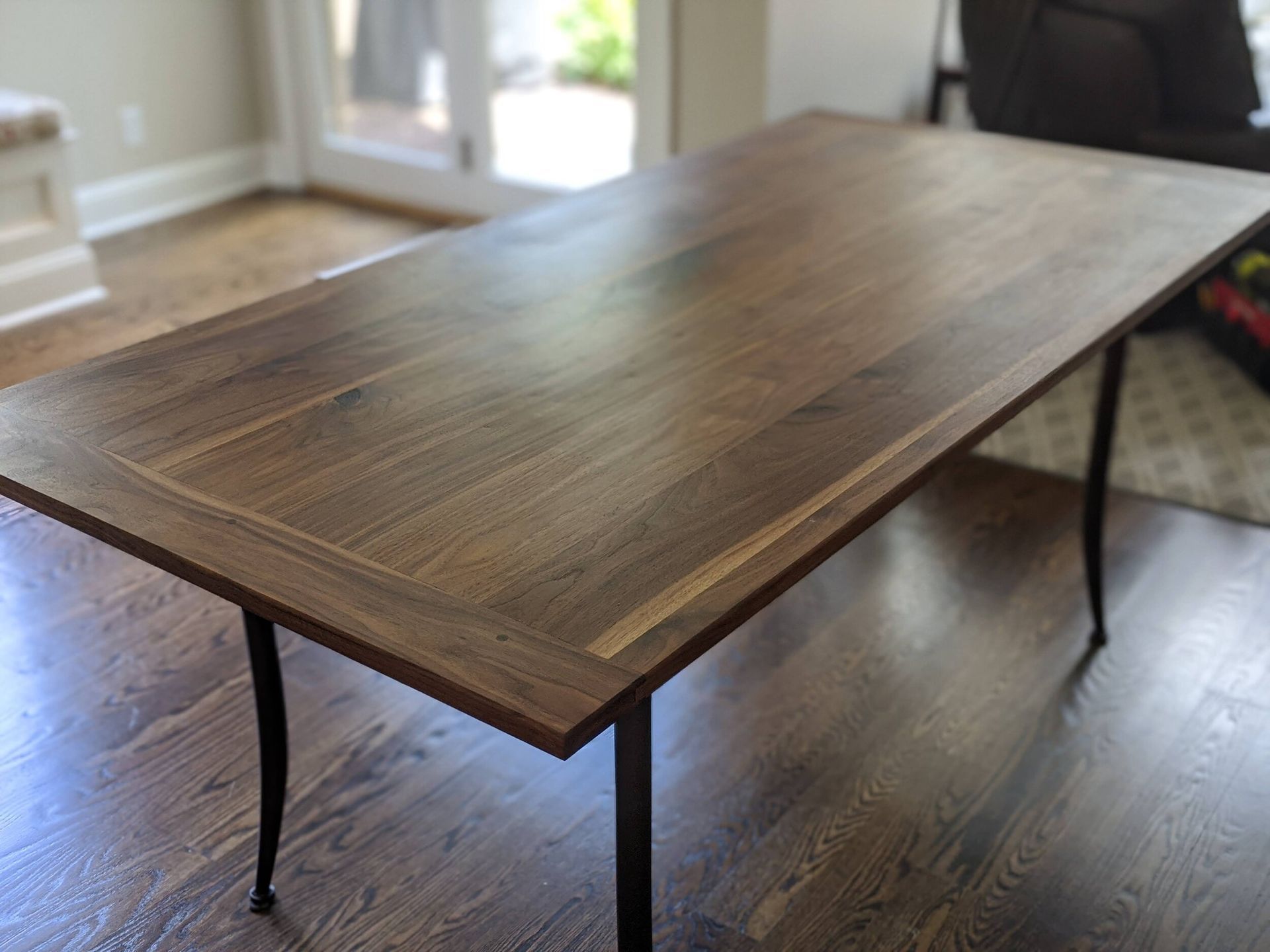 A wooden table is sitting on a wooden floor in a living room.