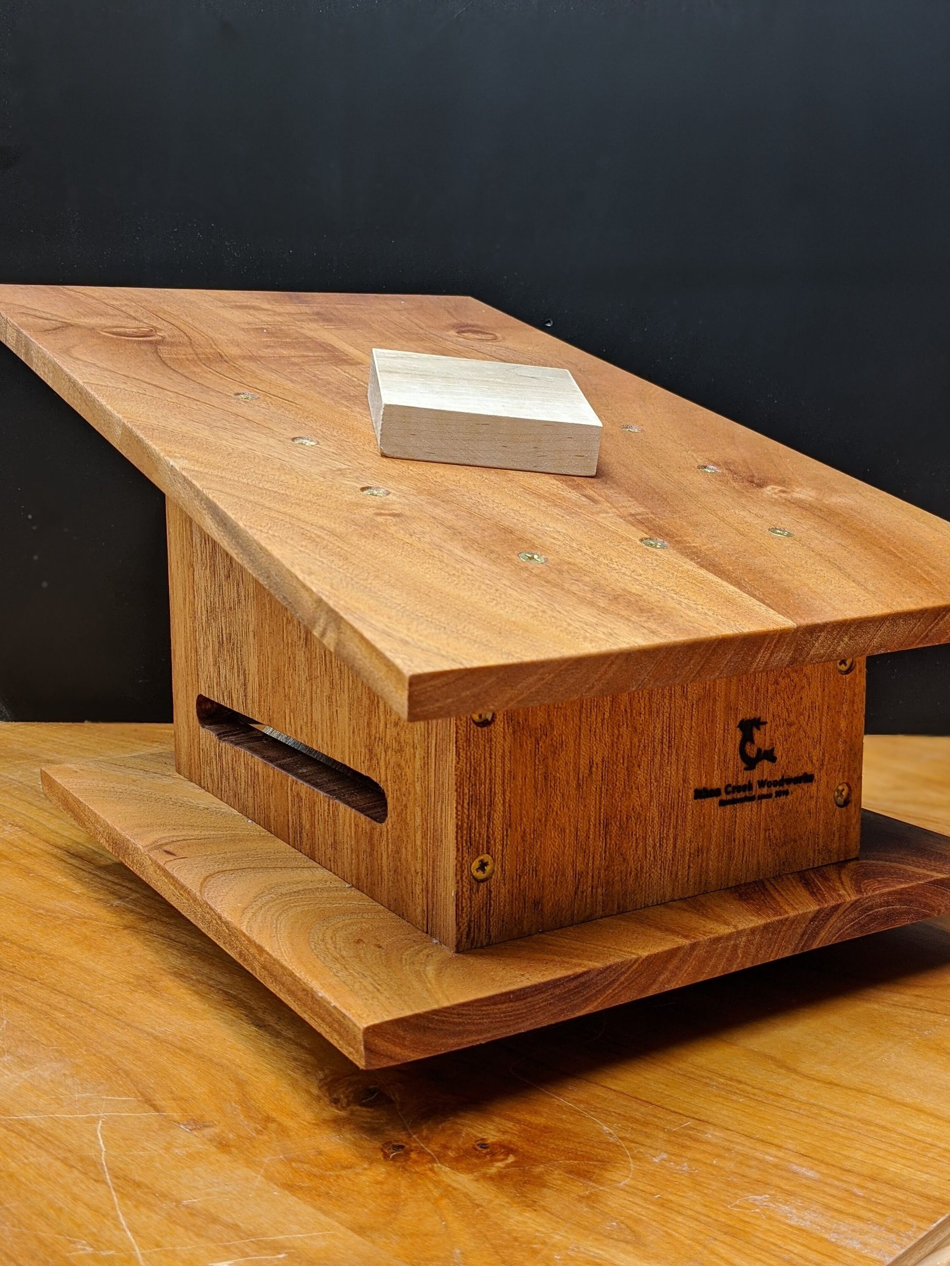 A wooden table with a brick on top of it.