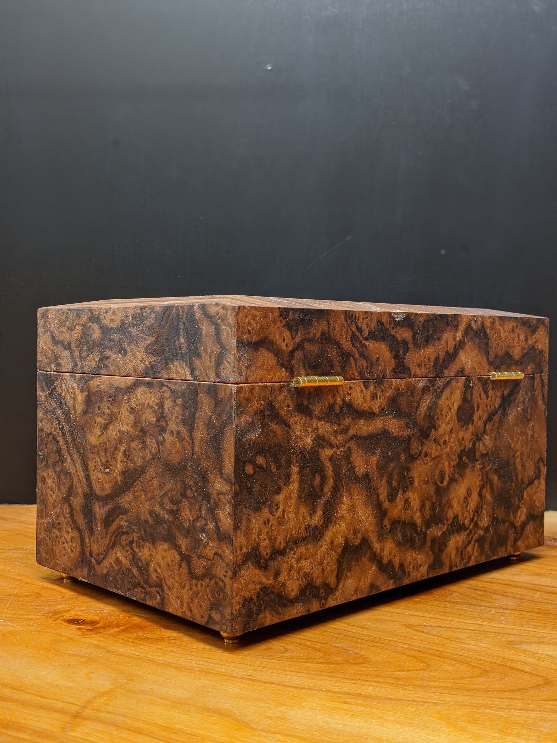 A wooden box is sitting on top of a wooden table.