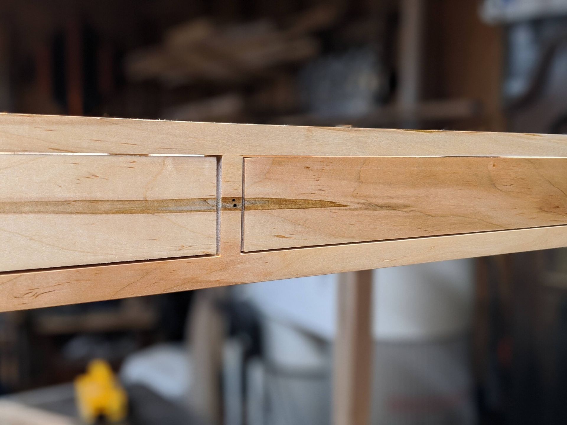 A piece of wood with a hole in the middle of it