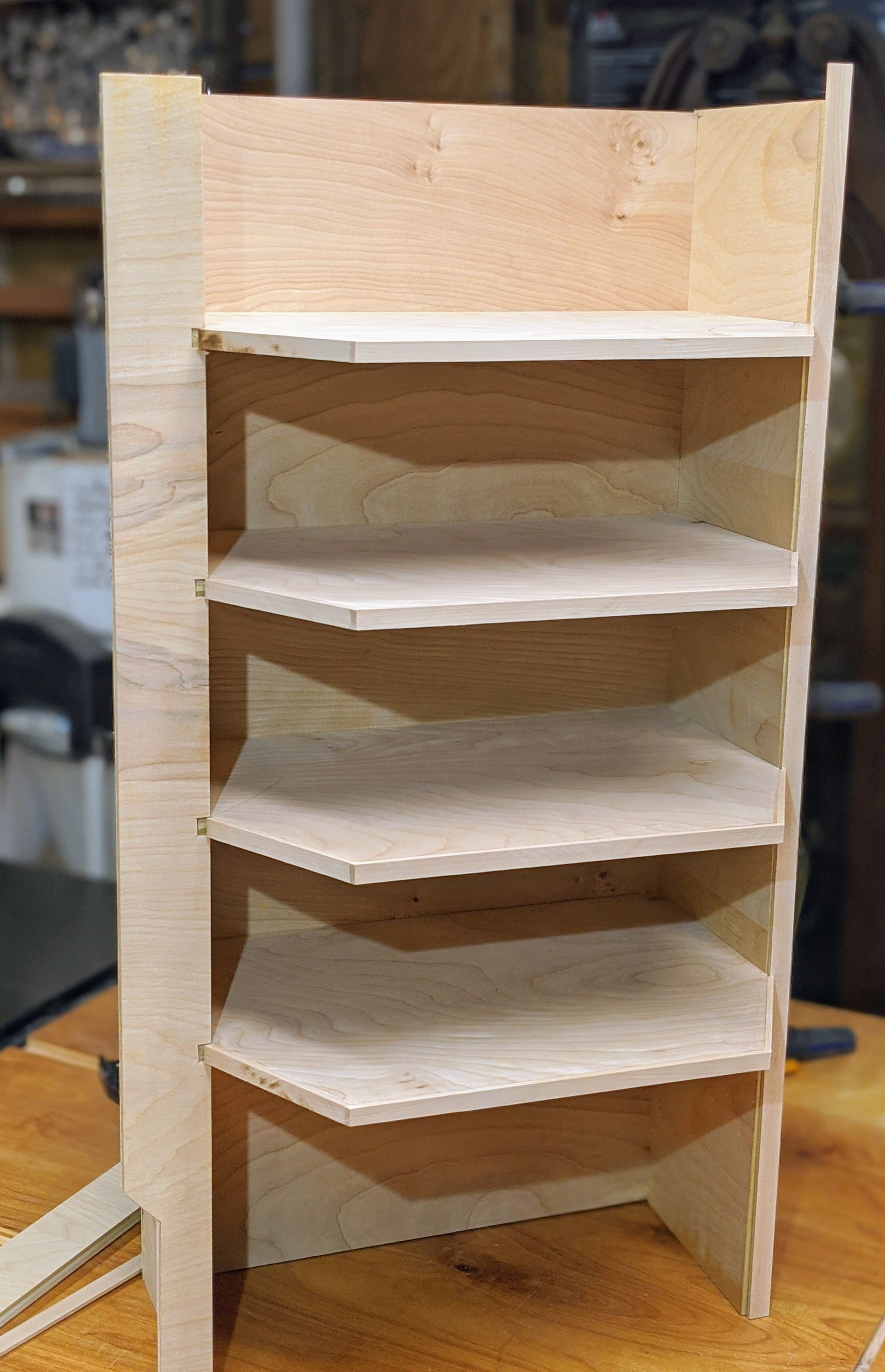 A wooden shelf is sitting on top of a wooden table.