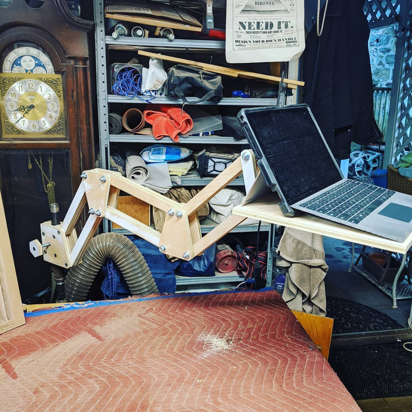 A laptop is sitting on a table with a sign that says needle on it