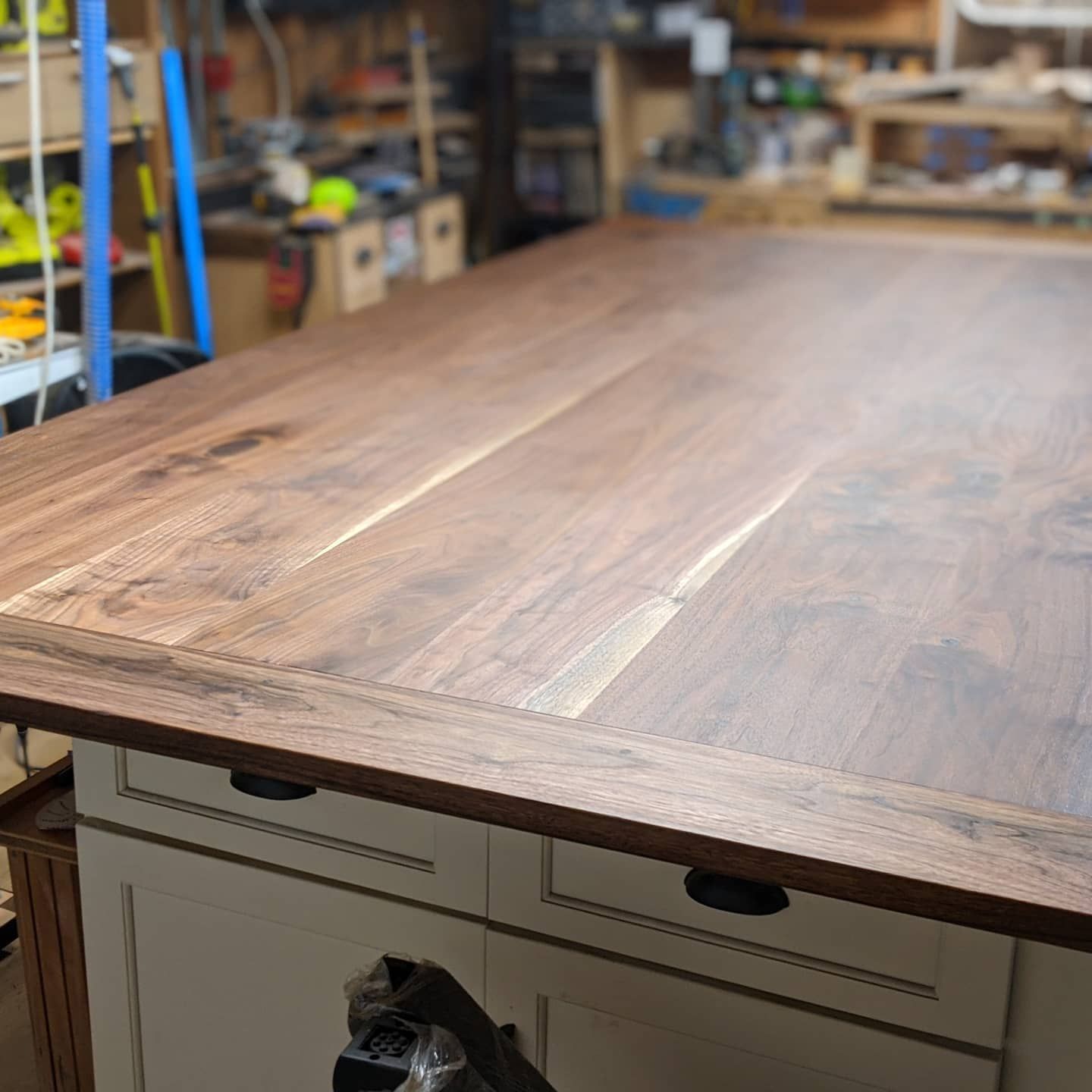 A wooden table with drawers underneath it in a room.