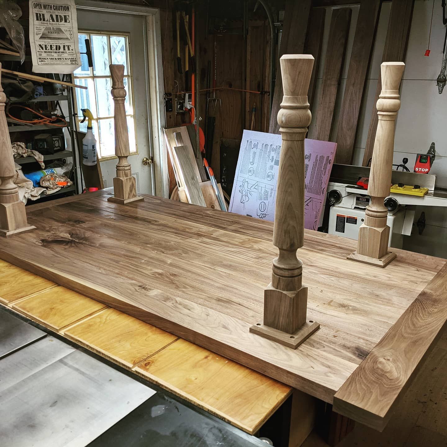 A wooden table is being made in a workshop.