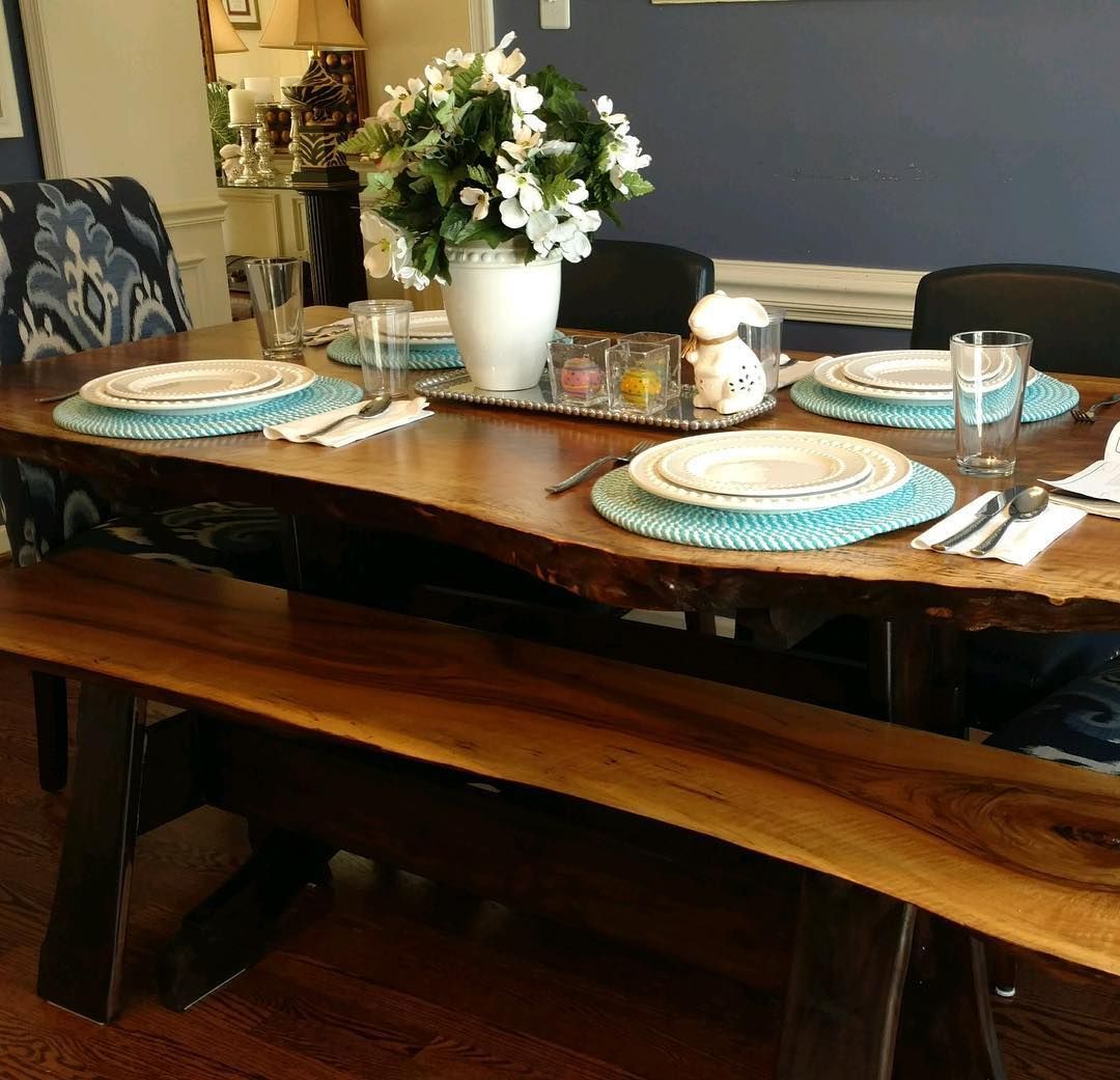 A dining room table with plates and utensils on it