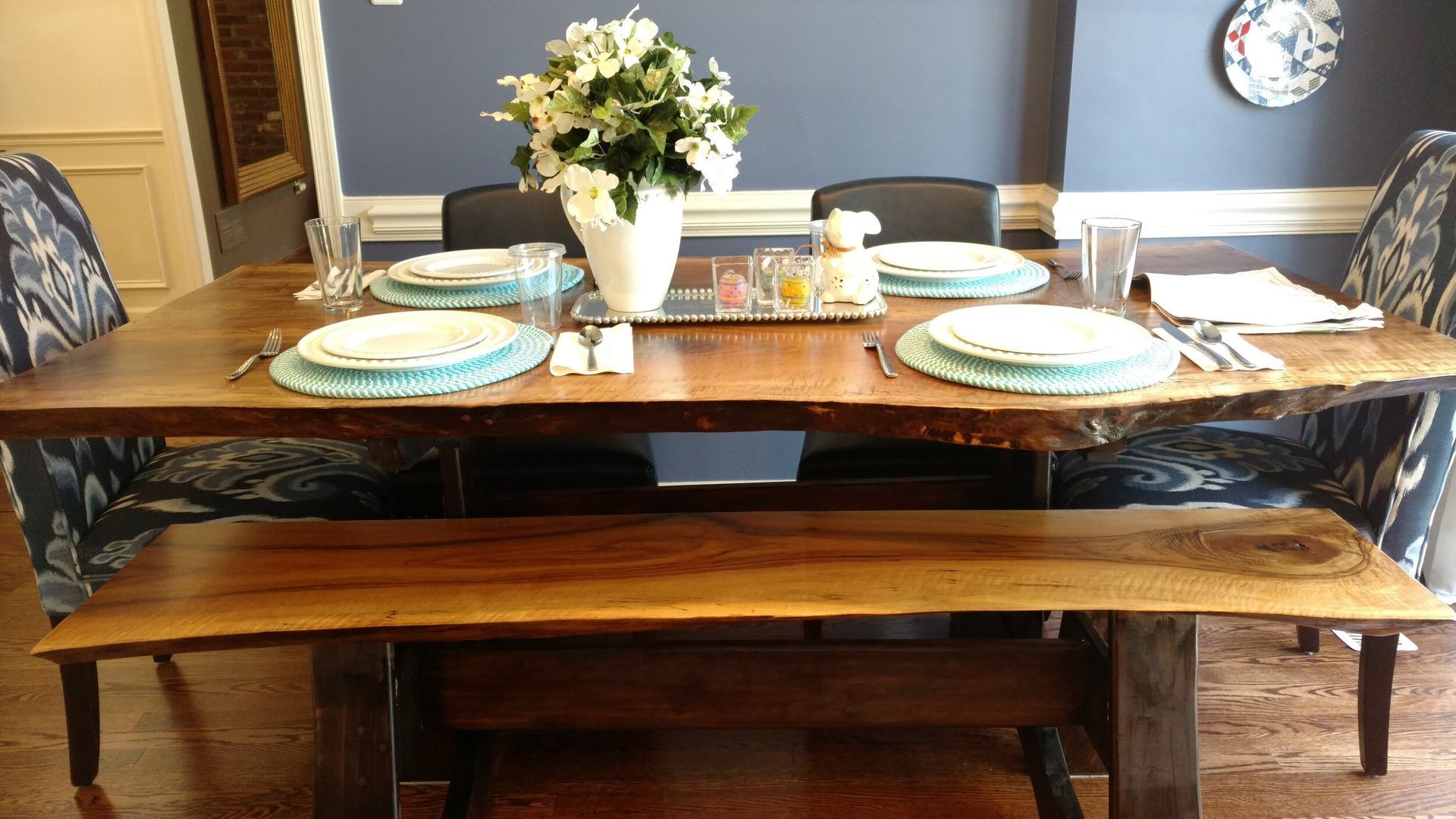 A dining room table with plates and utensils on it