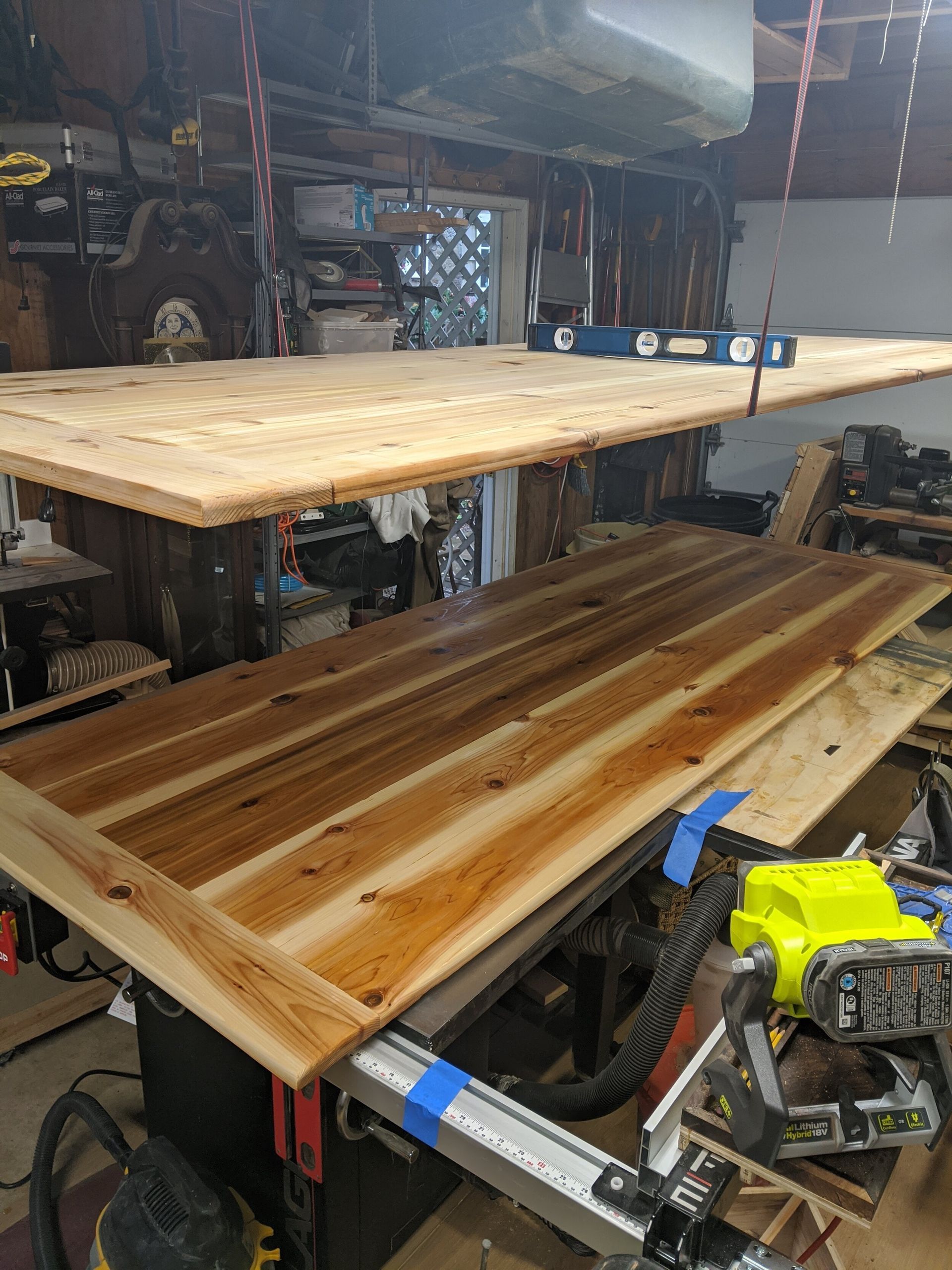 A large piece of wood is sitting on top of a table in a garage.