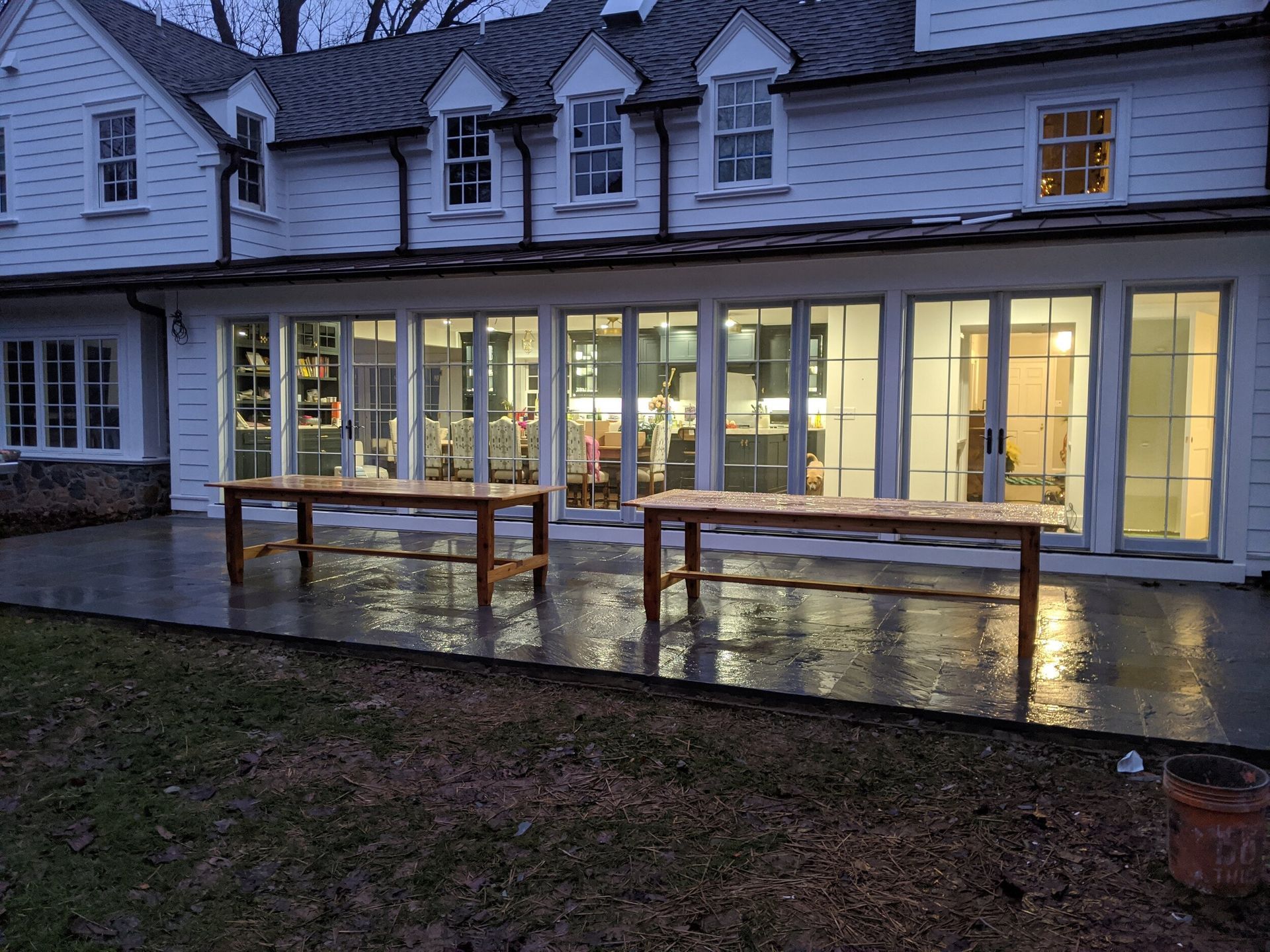 A large white house with a lot of windows and tables in front of it