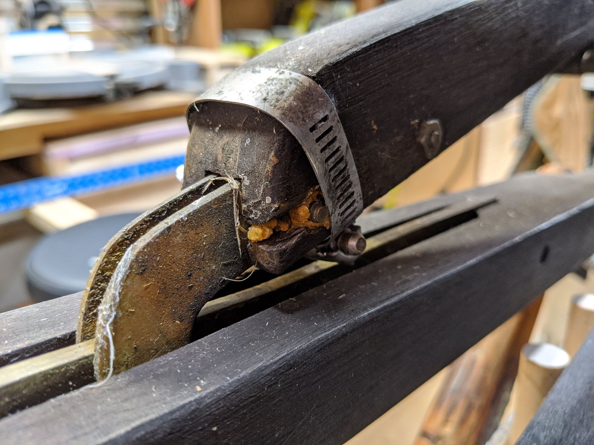A close up of a hose clamp on a piece of wood