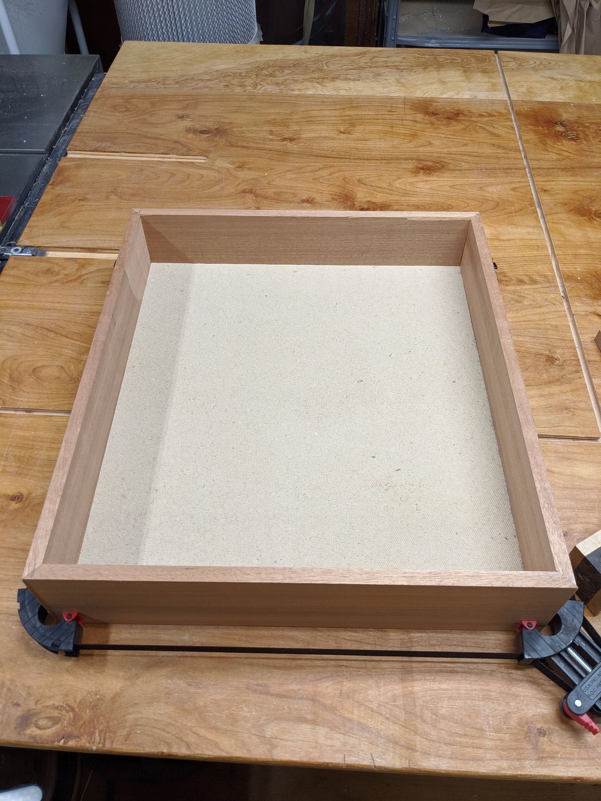 A wooden tray is sitting on top of a wooden table.