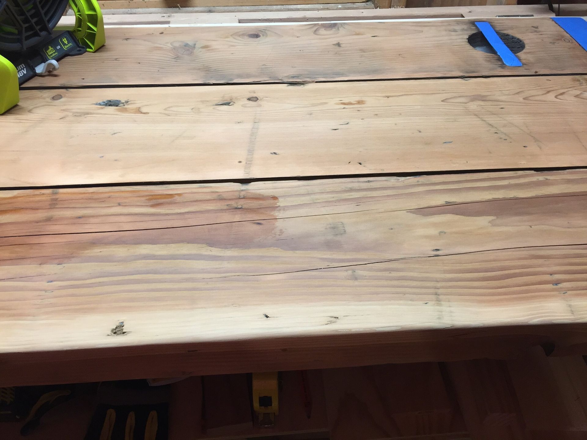 A piece of wood is sitting on top of a wooden table.