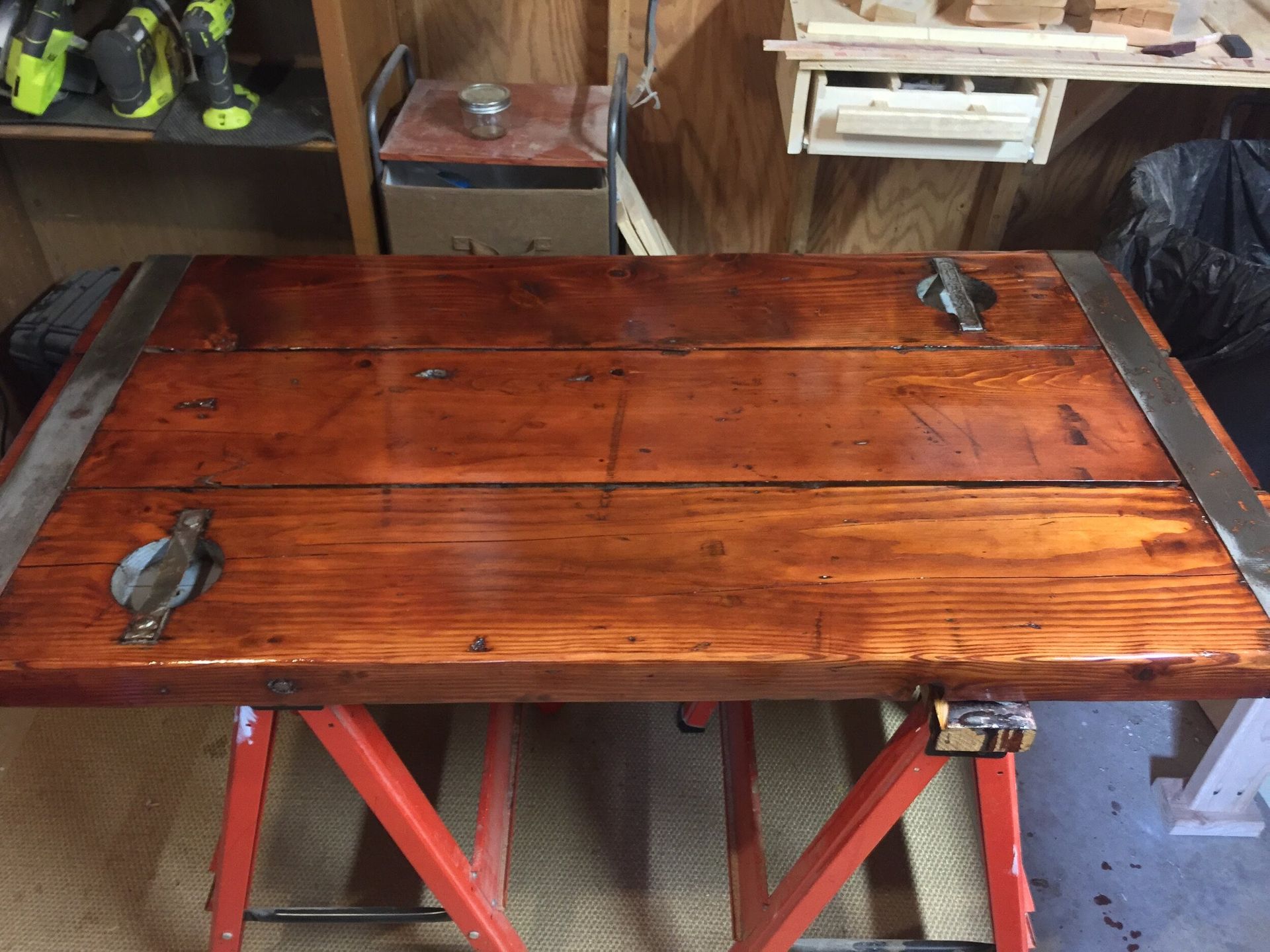 A wooden table with a saw on top of it