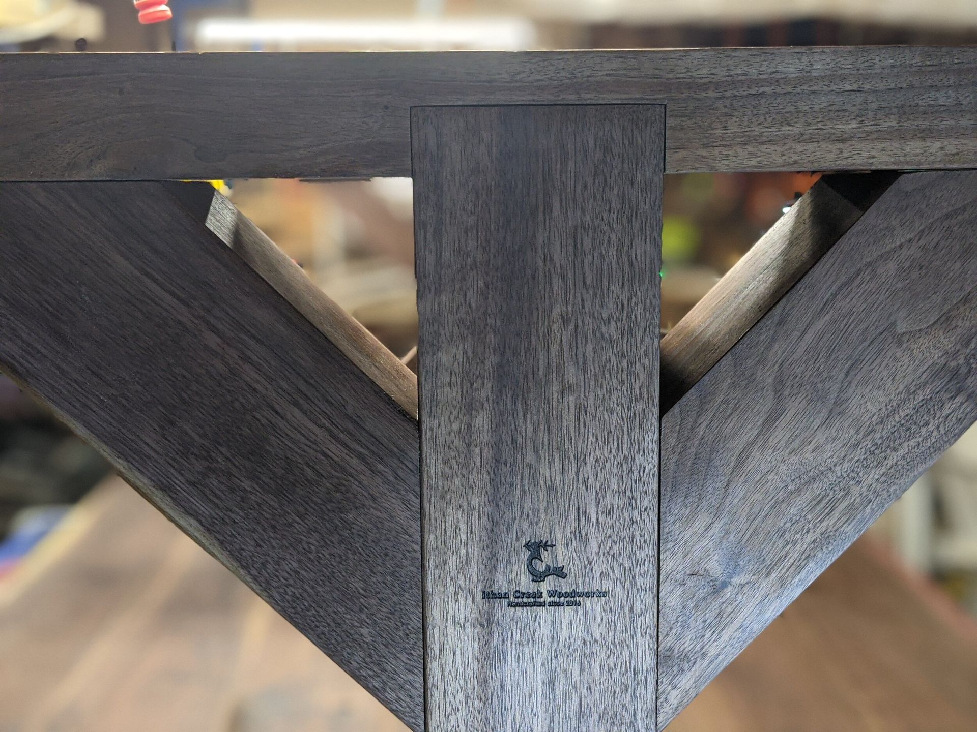 A close up of a wooden table with the letter k on it