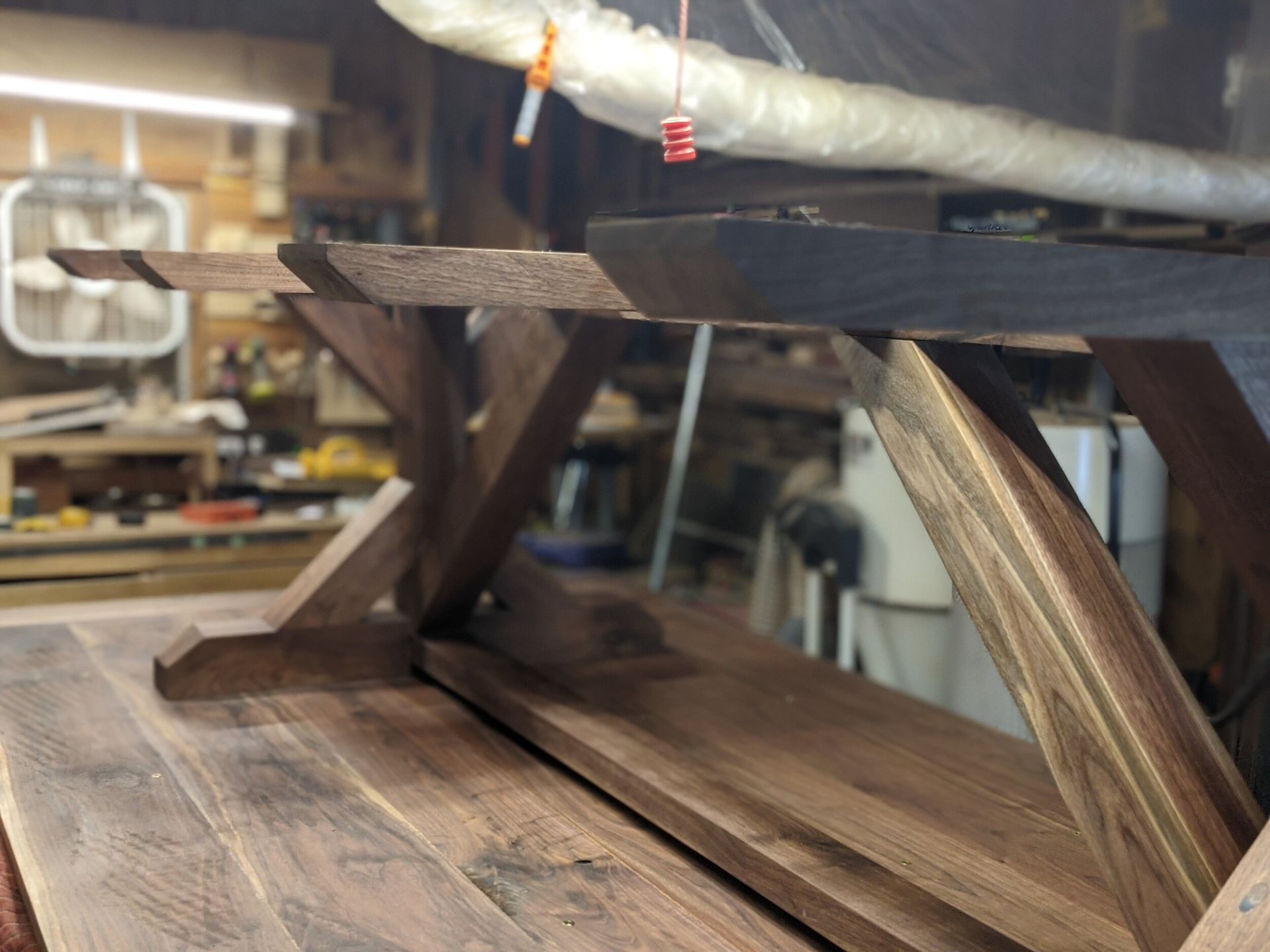 A wooden table is being built in a workshop