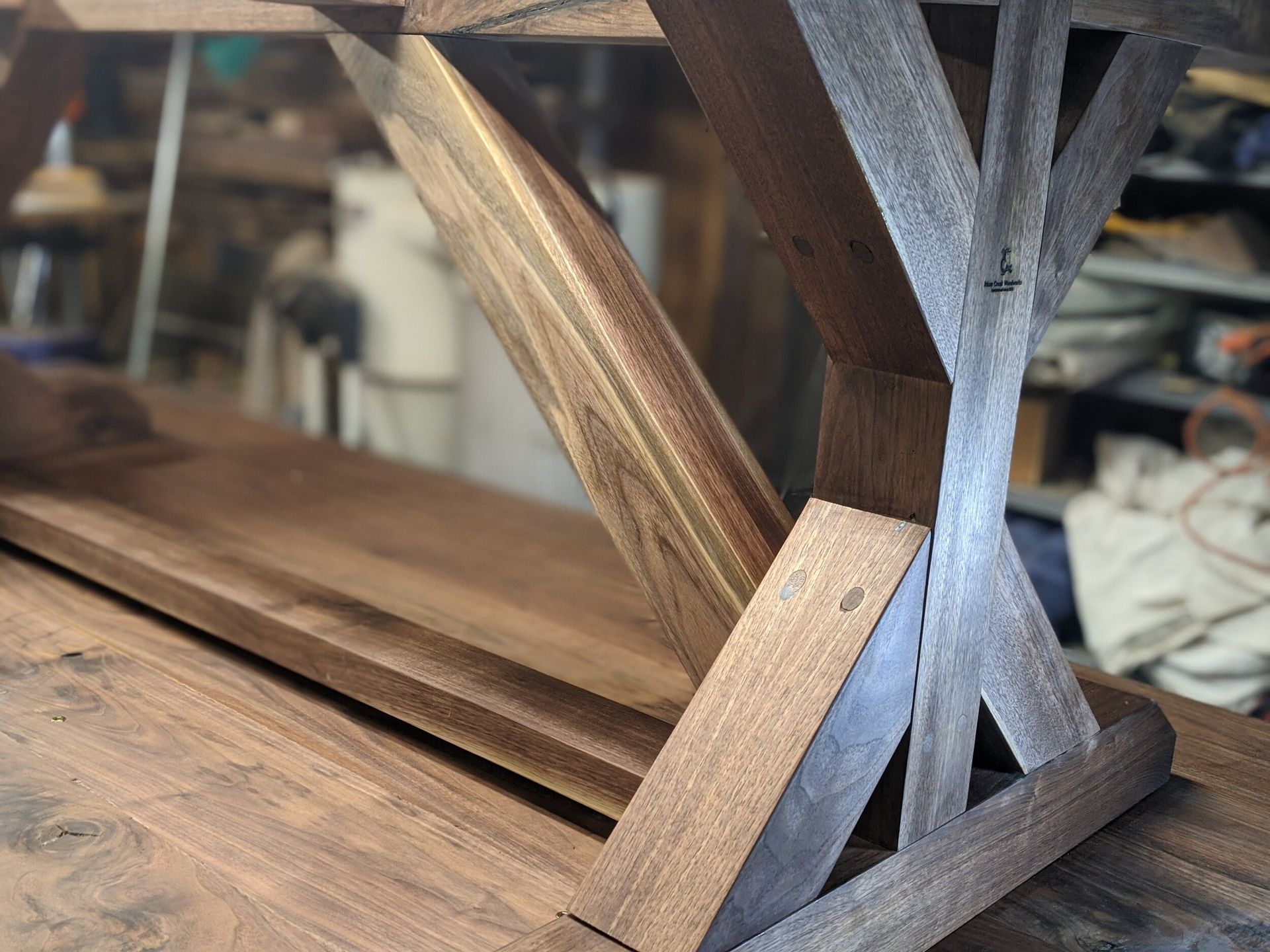A wooden table with a metal frame is sitting on top of a wooden table.