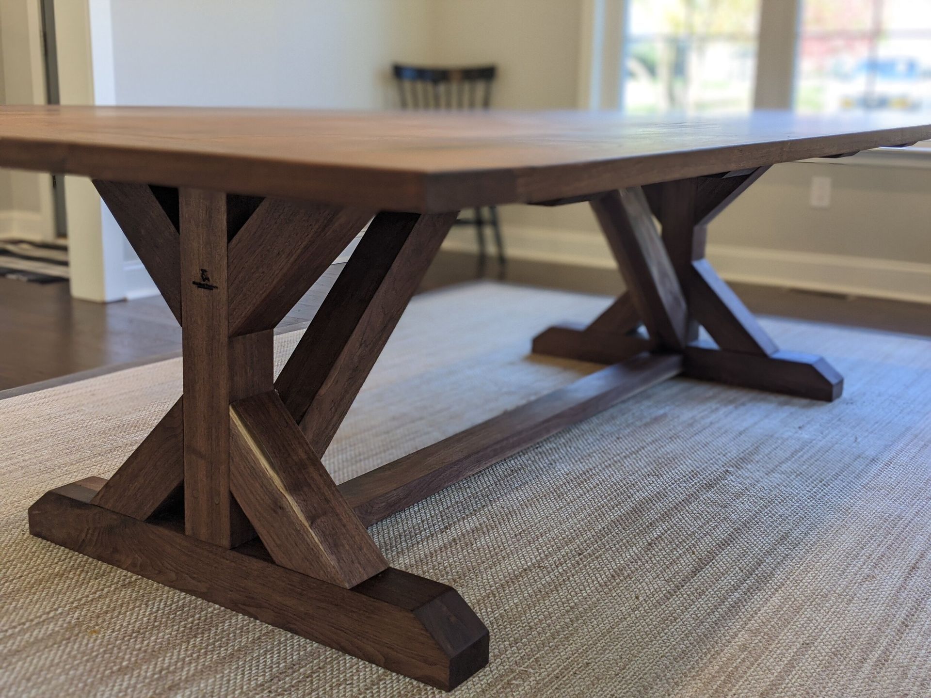 A wooden table is sitting on a rug in a living room.
