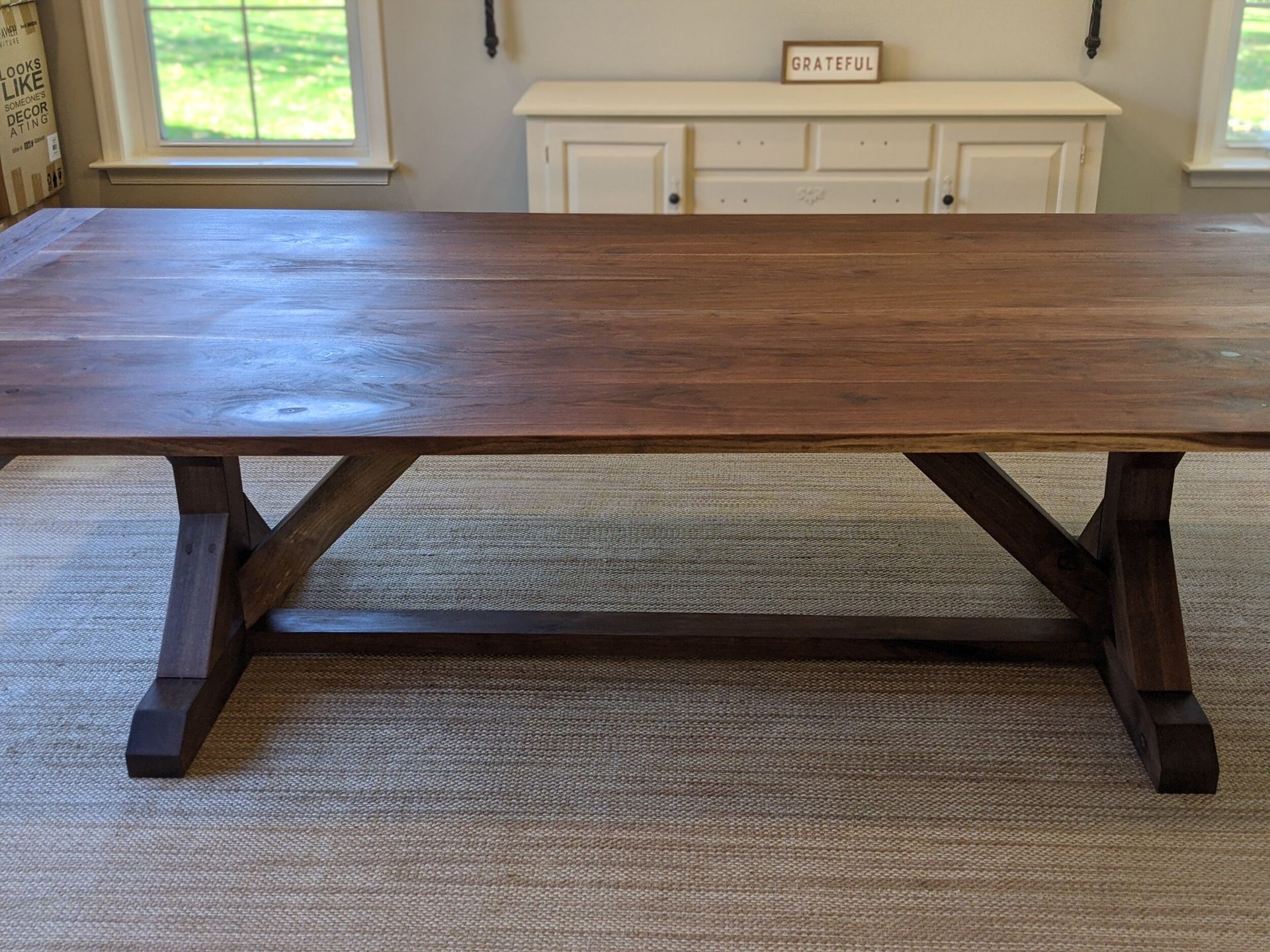 A wooden table is sitting on a rug in a living room.