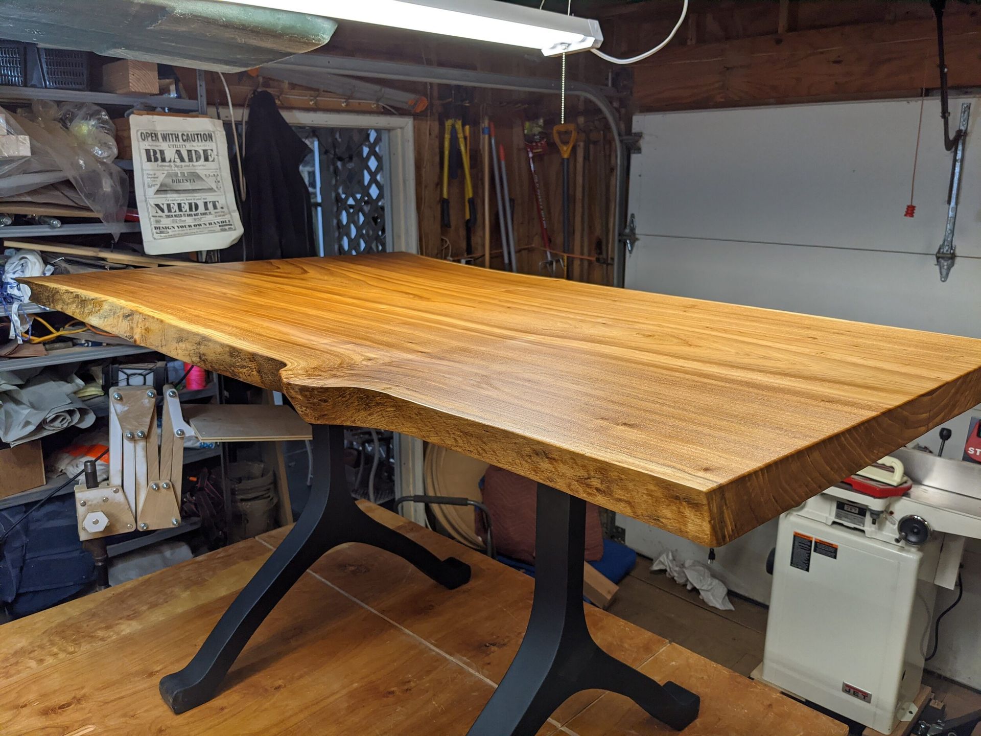 A wooden table is sitting on top of a wooden table in a garage.