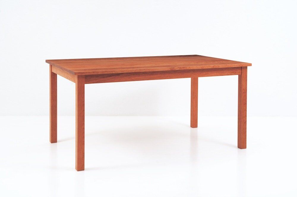 A wooden table is sitting on a white surface.