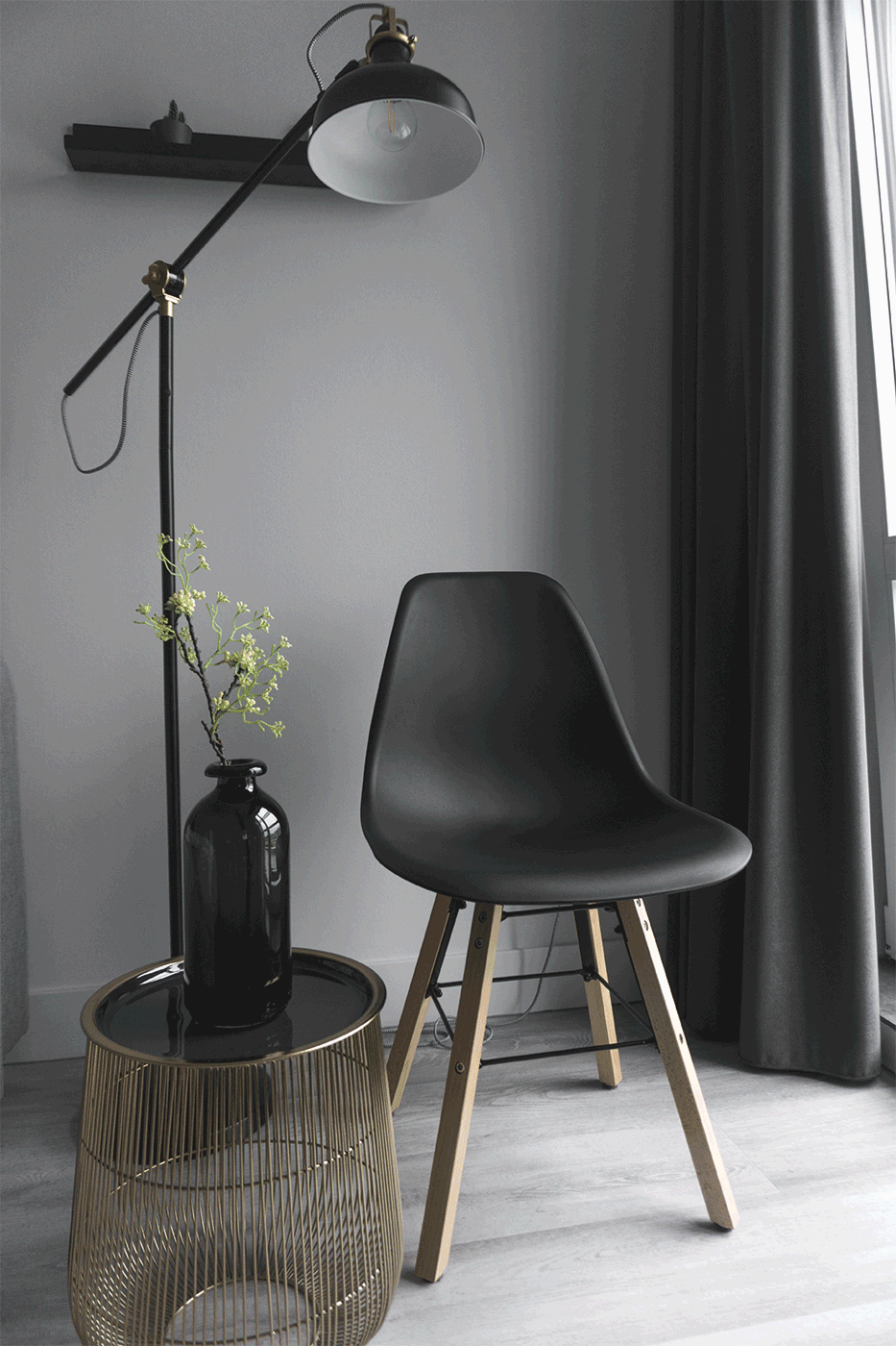 modern black chair and side table under a lamp
