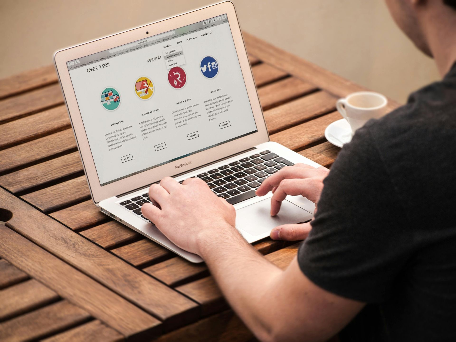 A man is typing on a laptop computer trying to improve his website to attract more local Melbourne clients