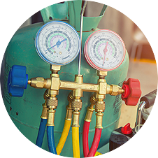 A bunch of gauges are sitting on top of a green tank.