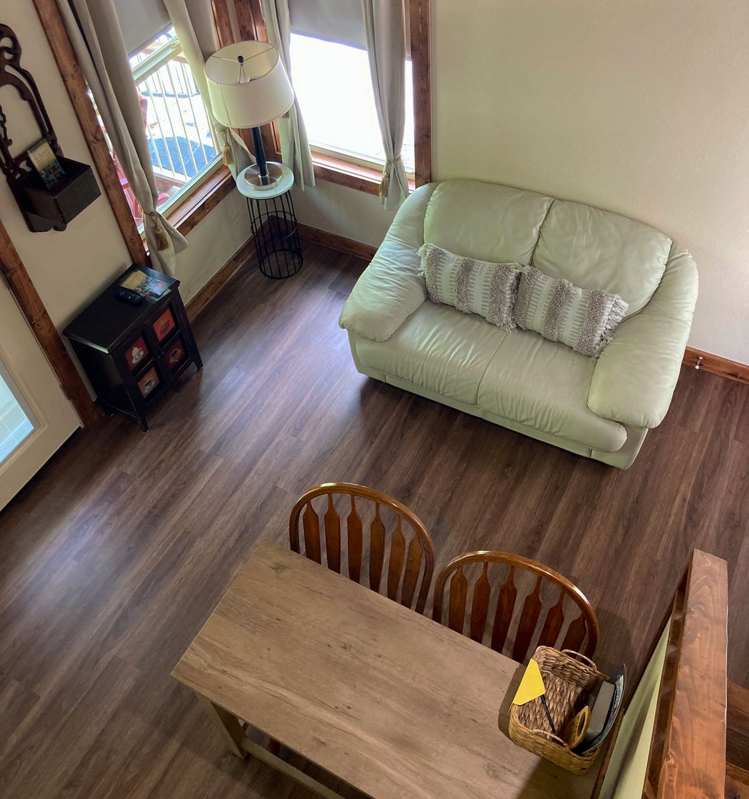 An aerial view of a living room with a couch , table and chairs