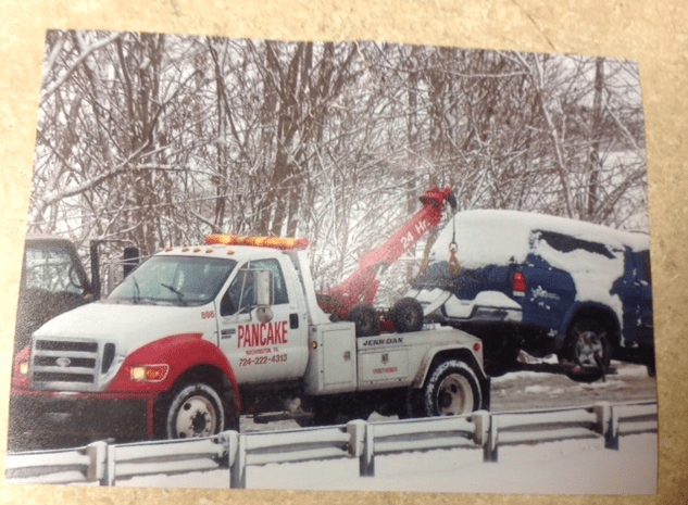Pancake Towing white tow truck in snow in Was