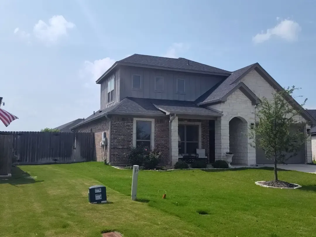 A large house with a large lawn in front of it