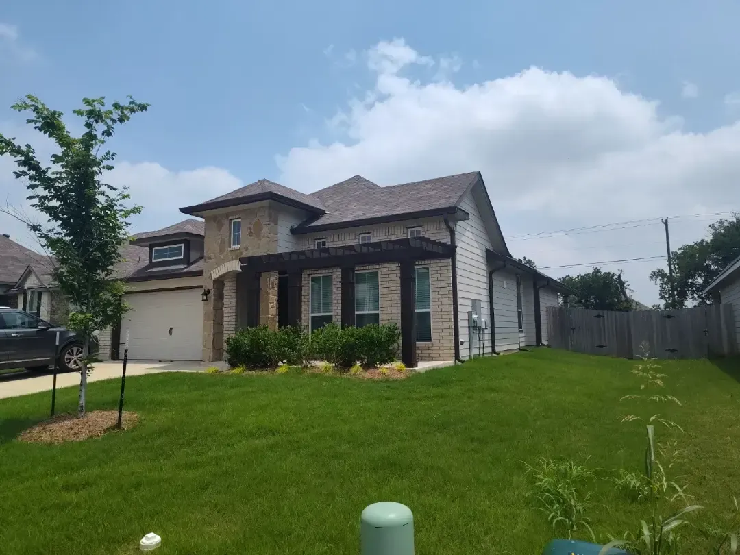 A large house with a large lawn in front of it
