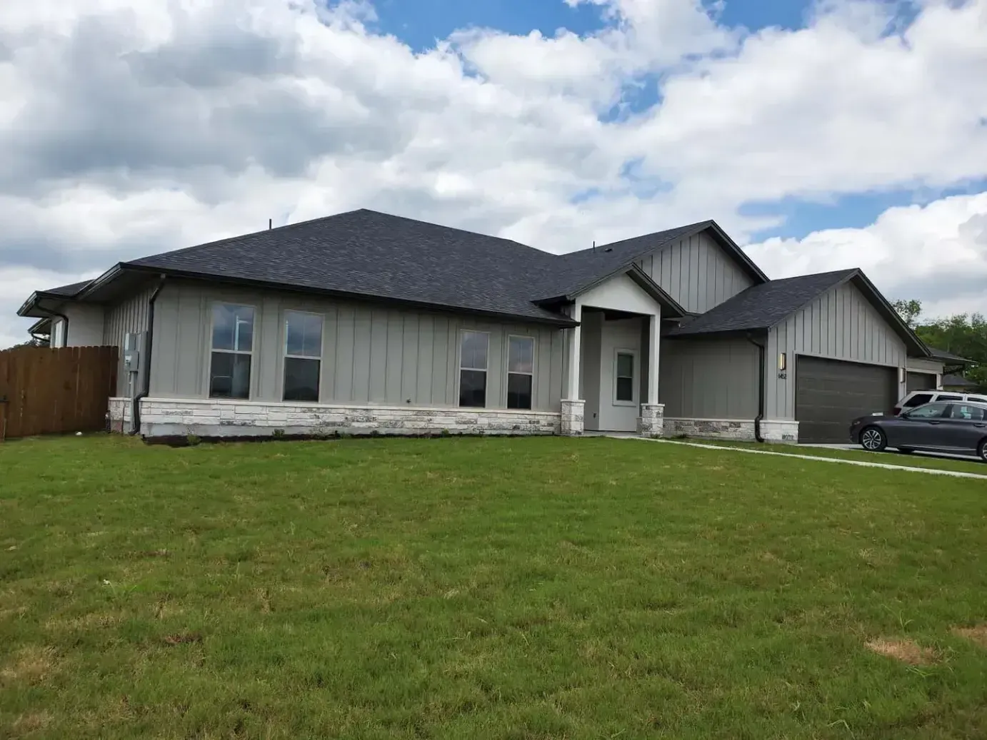 A large house with a car parked in front of it