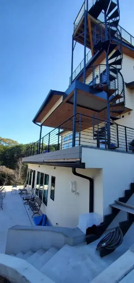 A house with a spiral staircase on the side of it.