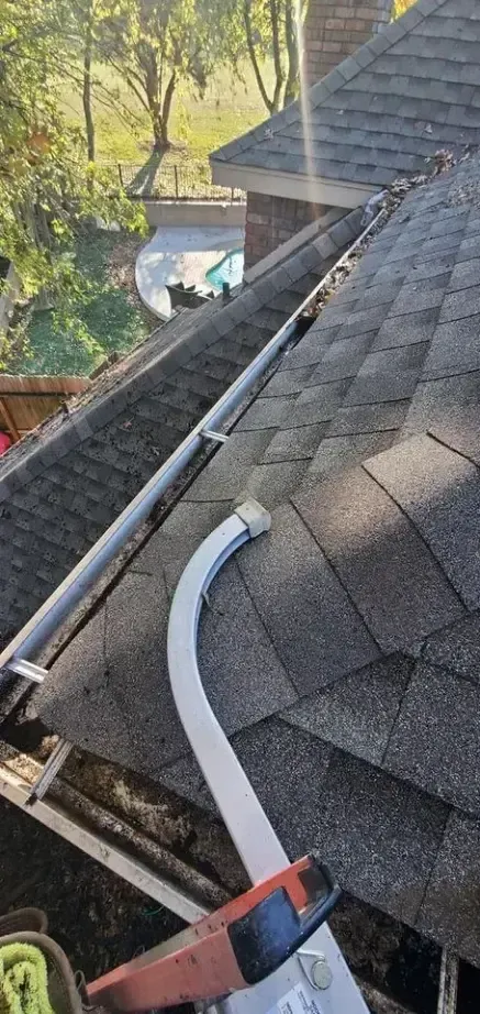 A gutter is being installed on the roof of a house.