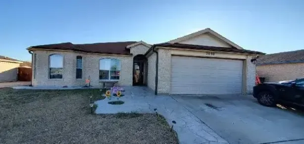 A house with a truck parked in front of it.