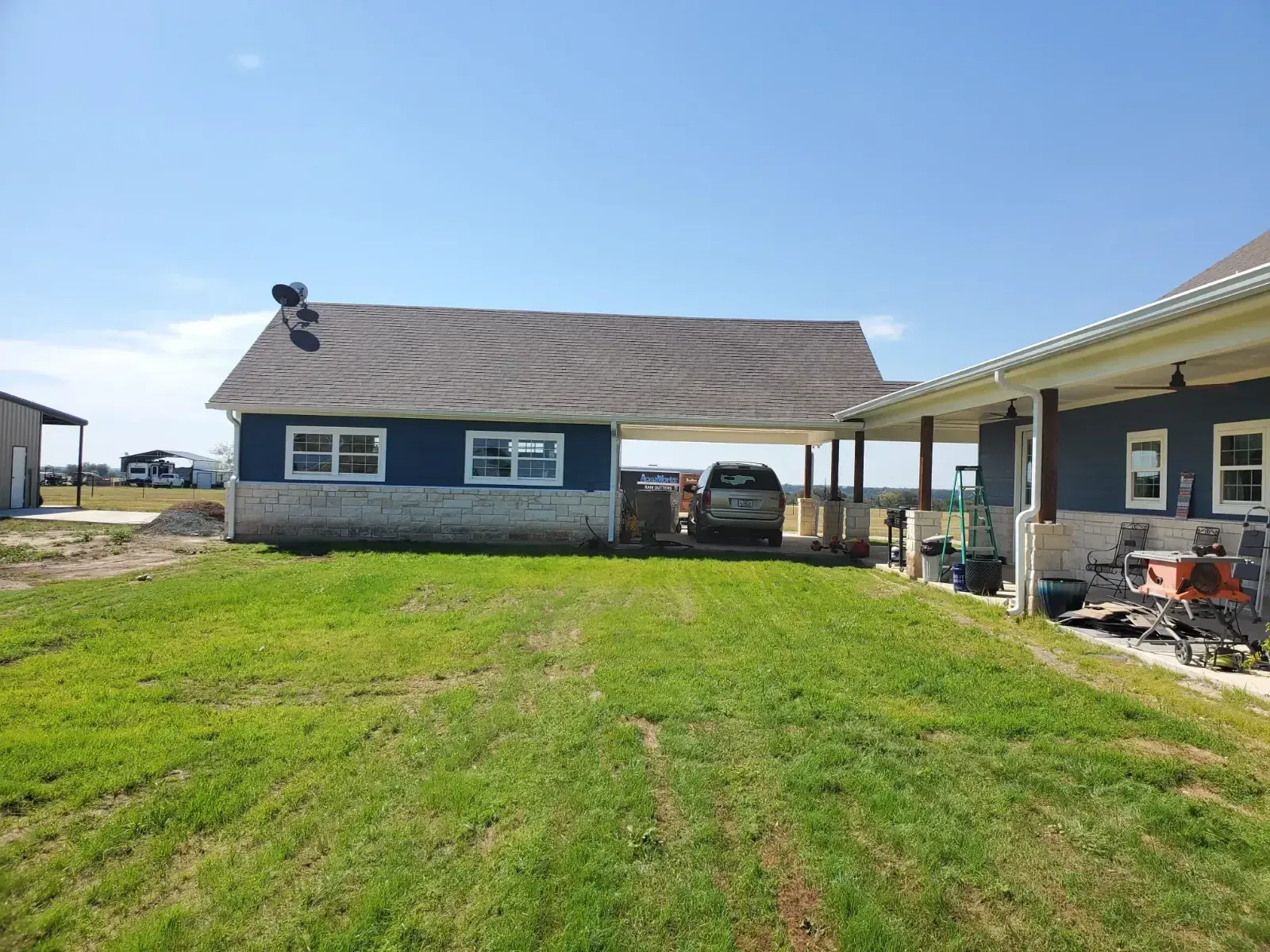 A house with a carport and a car parked in front of it.