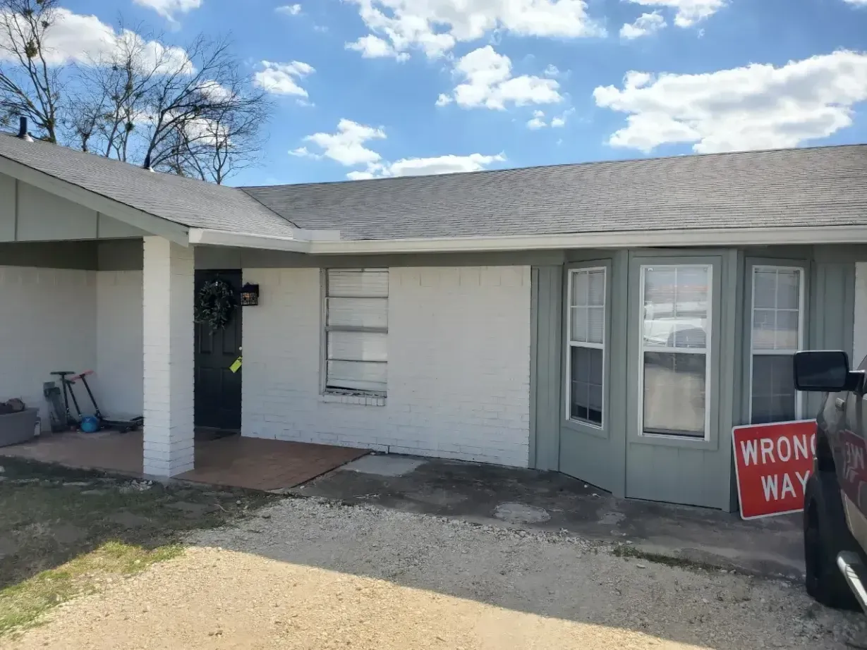 A white house with a red wrong way sign in front of it