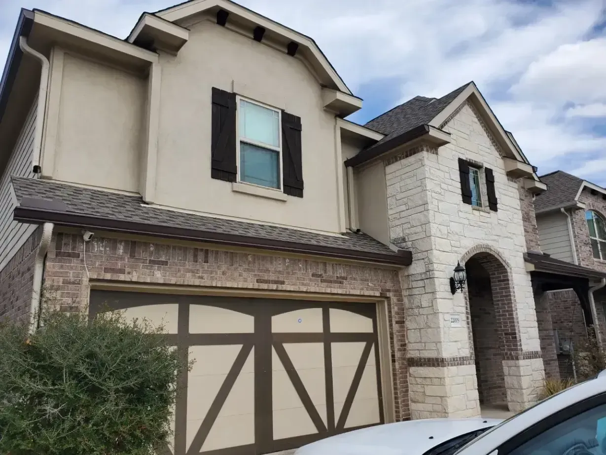 A house with a car parked in front of it