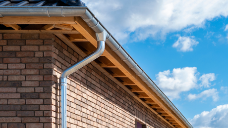 The right color - Living room with a cream-colored couch, blue armchairs, and colorful abstract artwork.