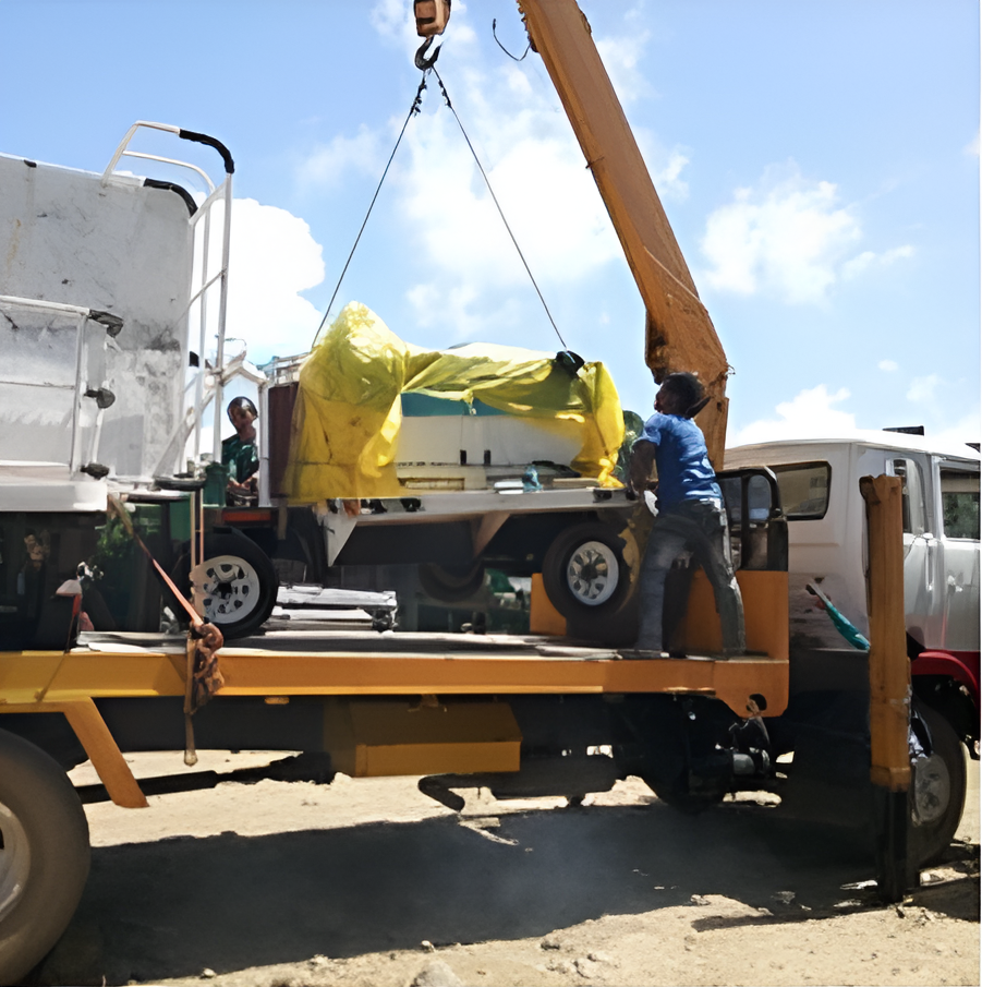 Truck Crane Lifting Equipment Wrapped in Yellow Tarp from A Truck Bed — Kerubin Logistics Inc in the Philippines