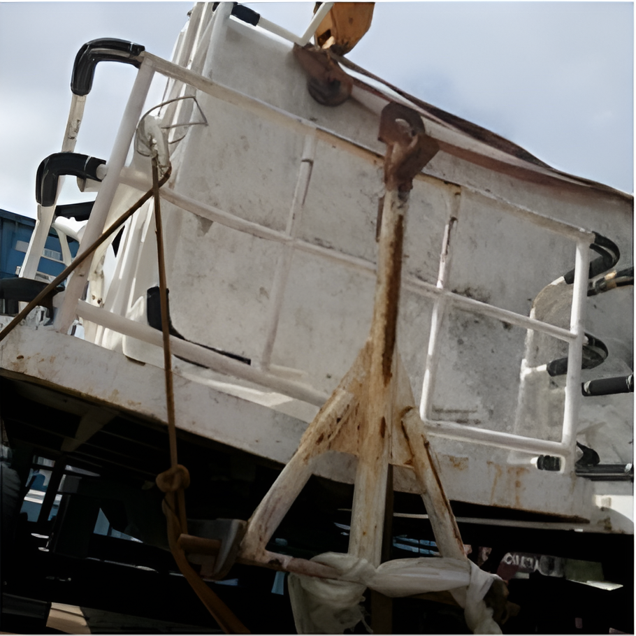 White Metal Frame, Possibly a Boat Part, on A Rusty Support Stand Outdoors — Kerubin Logistics Inc in the Philippines