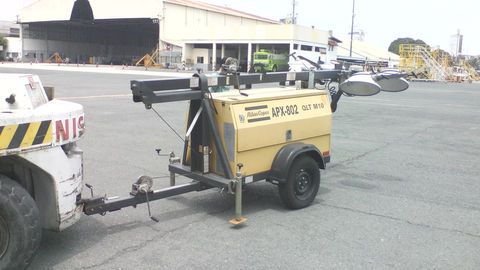 A Yellow Portable Light Tower Being Towed by A White Airport Tug on A Gray Tarmac — Kerubin Logistics Inc in the Philippines